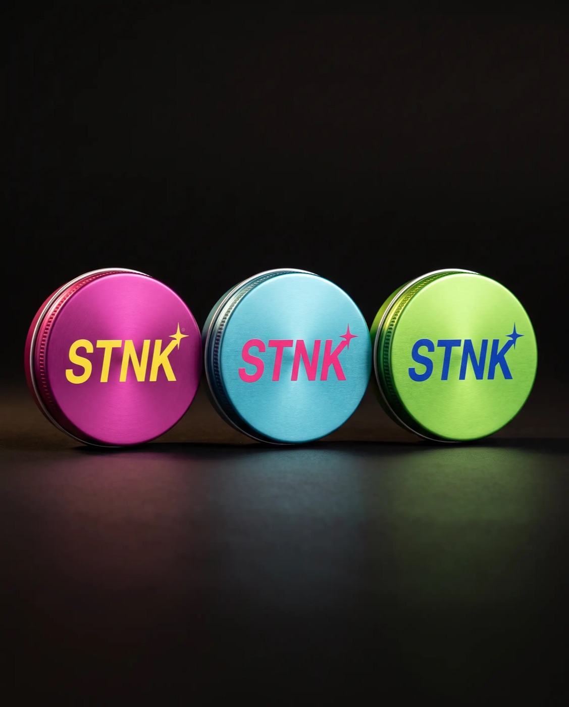 The three STNK tins side by side: Blood Orange, Coastal Coconut and Dirty Martini